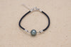 Bracelet en coton de couleur noir avec une perle de tahiti ovale