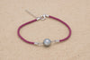 Bracelet coton soyeux de couleur rose avec une perle de tahiti ovale