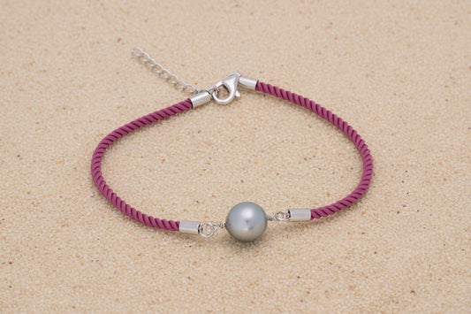 Bracelet coton soyeux de couleur rose avec une perle de tahiti ovale